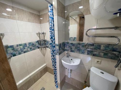 a bathroom with a toilet and a sink and a shower at Poilsis Preiloje-91 in Neringa
