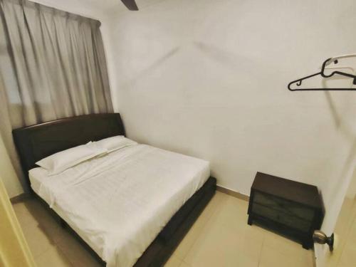 a small bedroom with a bed and a window at Setia Alam @ SCCC 3 Storey House in Shah Alam
