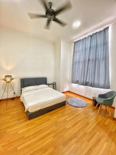 a bedroom with a bed and a ceiling fan at Setia Alam @ SCCC 3 Storey House in Shah Alam