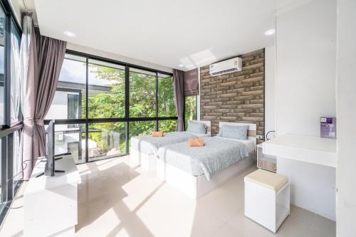 Ένα ή περισσότερα κρεβάτια σε δωμάτιο στο AnB Loft poolvilla 3BR/3bath close Jomtian beach