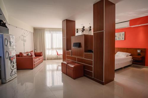 a room with a bedroom with a bed and a couch at Shoshana Hotel Boutique in Buenos Aires