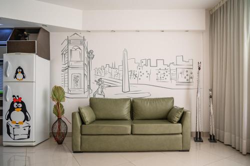 a living room with a couch and a drawing on the wall at Shoshana Hotel Boutique in Buenos Aires