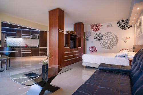 a bedroom with a bed and a living room at Shoshana Hotel Boutique in Buenos Aires