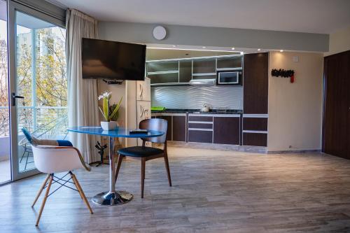 a kitchen with a table and chairs in a room at Shoshana Hotel Boutique in Buenos Aires