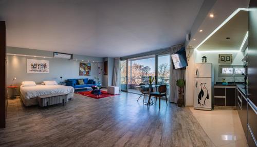 a bedroom with a bed and a kitchen and a living room at Shoshana Hotel Boutique in Buenos Aires