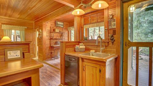 a kitchen with a sink in a wooden cabin at Dream Catcher Cabin - Meredith Lodging in Brightwood