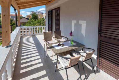 a patio with chairs and a table on a balcony at Apartman Tribunj in Tribunj