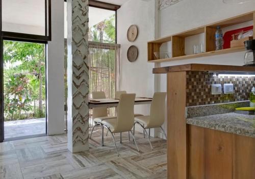 a kitchen and dining room with a table and chairs at Chaykovski Boutique H in Las Terrenas