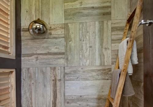 a room with a reclaimed wood wall with a hammock at Chaykovski Boutique H in Las Terrenas