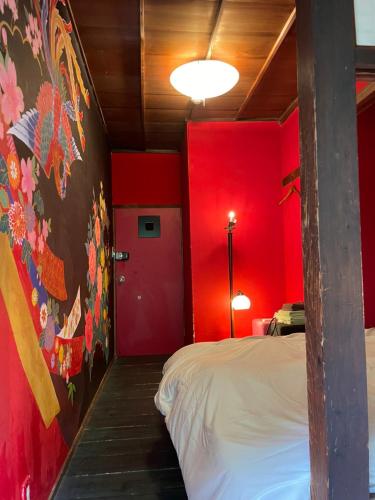 a red room with a bed and a red wall at Villa Sacra in Kamakura