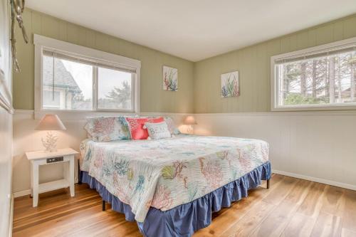 a bedroom with a bed and two windows at Lincoln House in Lincoln City
