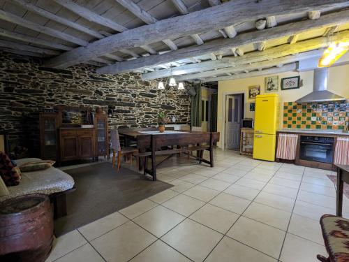 a kitchen with a table and a yellow refrigerator at Casa do Estevo in Francos