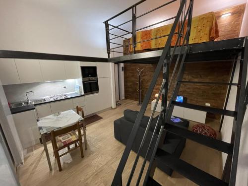 a living room with a bunk bed and a kitchen at Apartment Typex in Milan