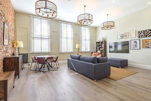a living room with a couch and a table at Oak & Poppy Apartments in London