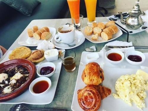 un tavolo ricoperto di piatti di prodotti per la colazione e bevande di Hotel la renaissance tata a Tatta