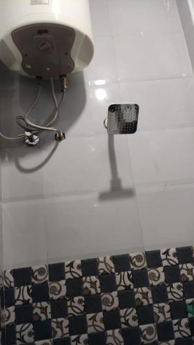 a bathroom with a sink and a black and white floor at Sri Sai Farm House in Puducherry