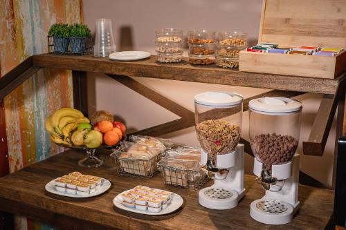 a table with fruits and other foods on a shelf at Shoshana Hotel Boutique in Buenos Aires