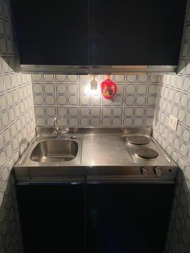 a small kitchen with a sink and a stove at Appartamento Val di Luce in Abetone