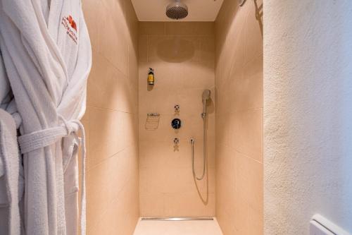 a shower in a bathroom with a shower curtain at Hotel Heiligenstein in Baden-Baden