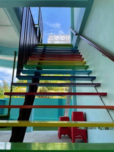 a staircase with colorful treads in a building at House of Happiness Homestay 幸福之家 in Bentong