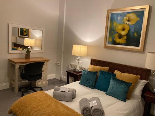 a bedroom with a bed with a desk and a computer at Beautiful holiday home near Plymouth for 4 in Plymouth