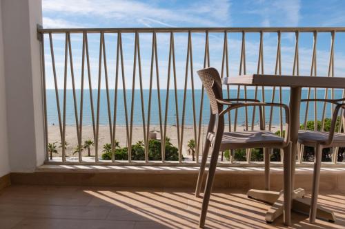 a balcony with a table and chairs and the beach at Fllad Resort & SPA Durres in Golem