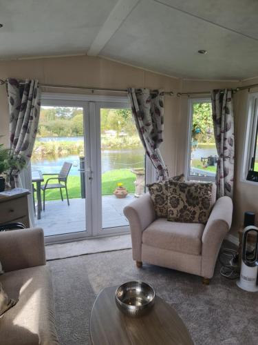 a living room with a couch and a table at Nicks and Carmels by the Lake in Carnforth