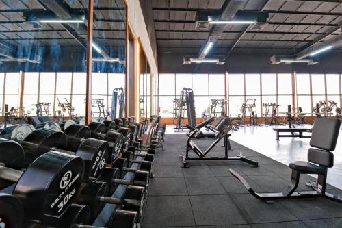 a gym with rows of dumbbells in a room at ALJAWHARA ALZARQAA FOR SERVISED APARTMENTS Est in Rabigh
