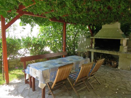 a table and chairs sitting under a gazebo at Apartments Janči, Murter (Croatia) in Murter