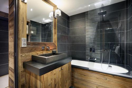 a bathroom with a sink and a bath tub at Megève centre in Megève