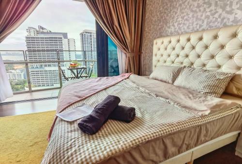 a bedroom with a large bed with a large window at 1519 Almas Suites SeaView Sunrise Netflix By STAY in Nusajaya