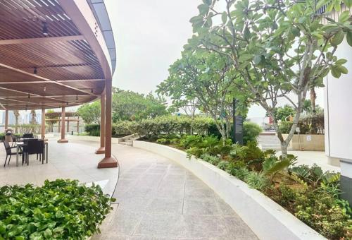 a patio with a table and chairs and trees at Almas Family Studio 100mbps Netflix By STAY in Nusajaya