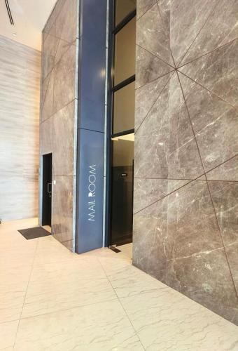a lobby of a building with a large stone wall at Almas Family Studio 100mbps Netflix By STAY in Nusajaya