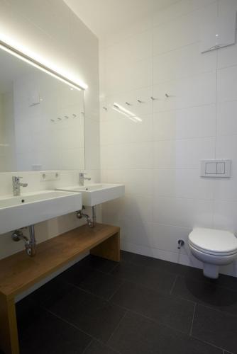 a bathroom with a sink and a toilet at Residence Bellevue - incl Summercard in Zell am See
