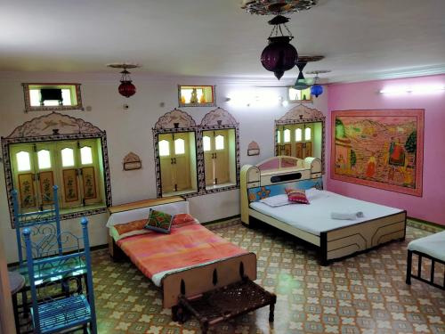 a large room with two beds and mirrors at Golden Dreams Guest House in Jodhpur