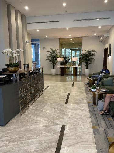 un hall d'un hôtel avec des personnes assises dans l'établissement Wonderful Reva Aparthotel Downtown, à Dubaï
