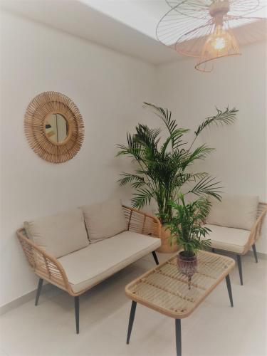 a living room with a couch and a potted plant at H Arena Mojacar in Mojácar