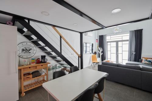 a living room with a table and a couch at Artist's Loft in the centre of Santa Cruz in Santa Cruz de Tenerife