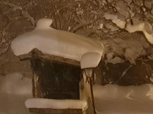 a snow covered bird house with snow on top of it at Casa vacanze Daniela in Villetta Barrea