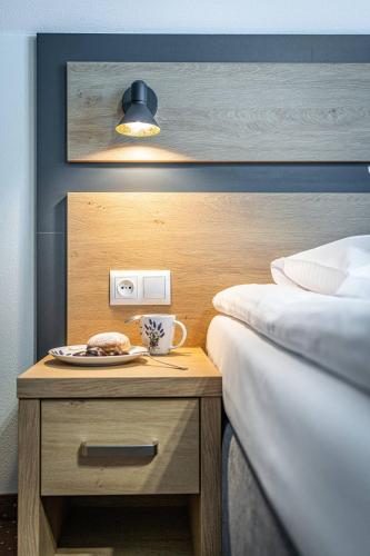 a nightstand with a plate of food on it next to two beds at Rezydencja Markowy Dworek in Białka Tatrzanska