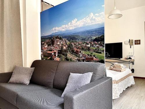 a living room with a couch and a view of a city at 10mt dal Duomo Ca del Duomo in Alba
