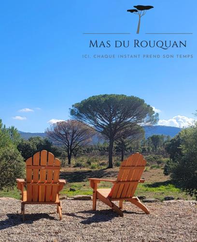two wooden chairs sitting next to each other at Le Mas du Rouquan in Vidauban