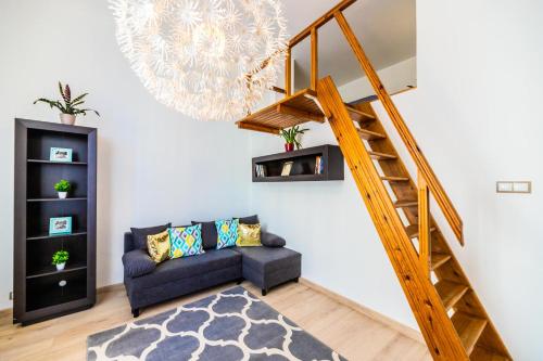 a living room with a couch and a staircase at VIP Apartments - Apartamenty na Leszczyńskiego in Wrocław