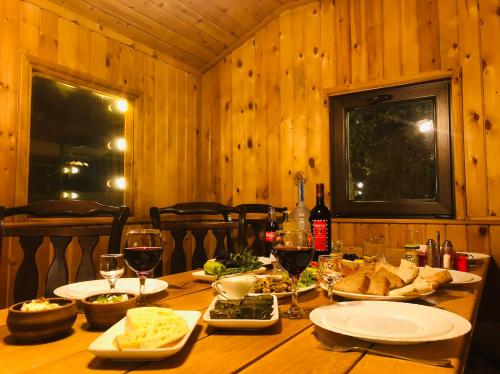 a wooden table with food and glasses of wine at Orran Hotel and Resort in Solak