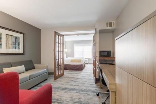 a living room with a couch and a bed at Country Inn & Suites by Radisson, Lewisville, TX in Lewisville