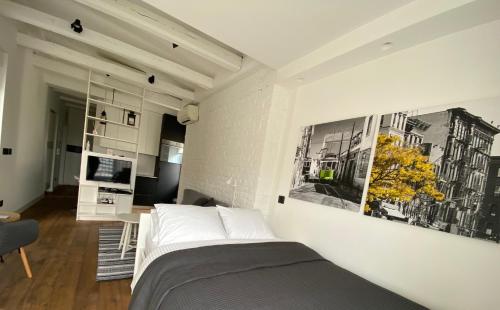 a bedroom with a bed and a living room at Enjoy B-52 Studio in Belgrade