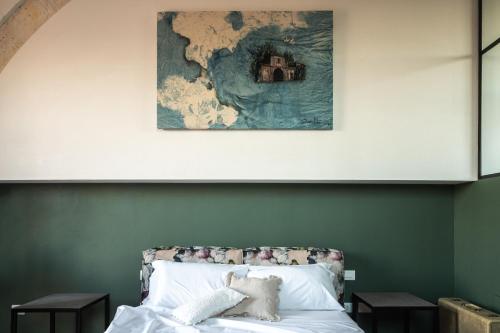 a bedroom with a bed with a map on the wall at Casa di Melo - Organic Country Hotel in Cassibile