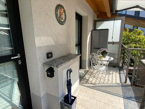 a patio with a refrigerator and a table on a balcony at CasaMartaNavigli in Milan