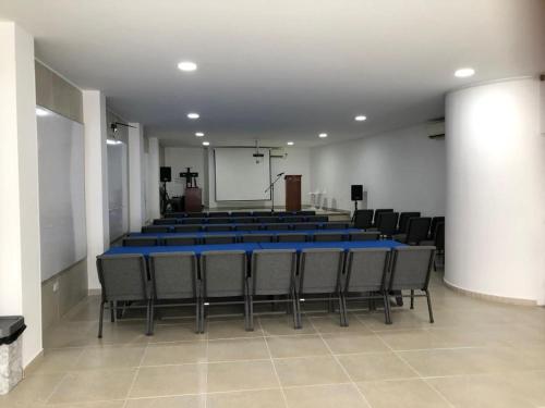 a conference room with a blue table and chairs at Colon Plaza Hotel in Tumaco
