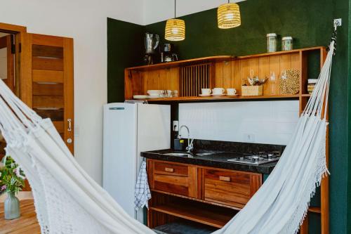 a kitchen with two hanging hammocks in a room at Recanto Alter do Chão in Alter do Chao